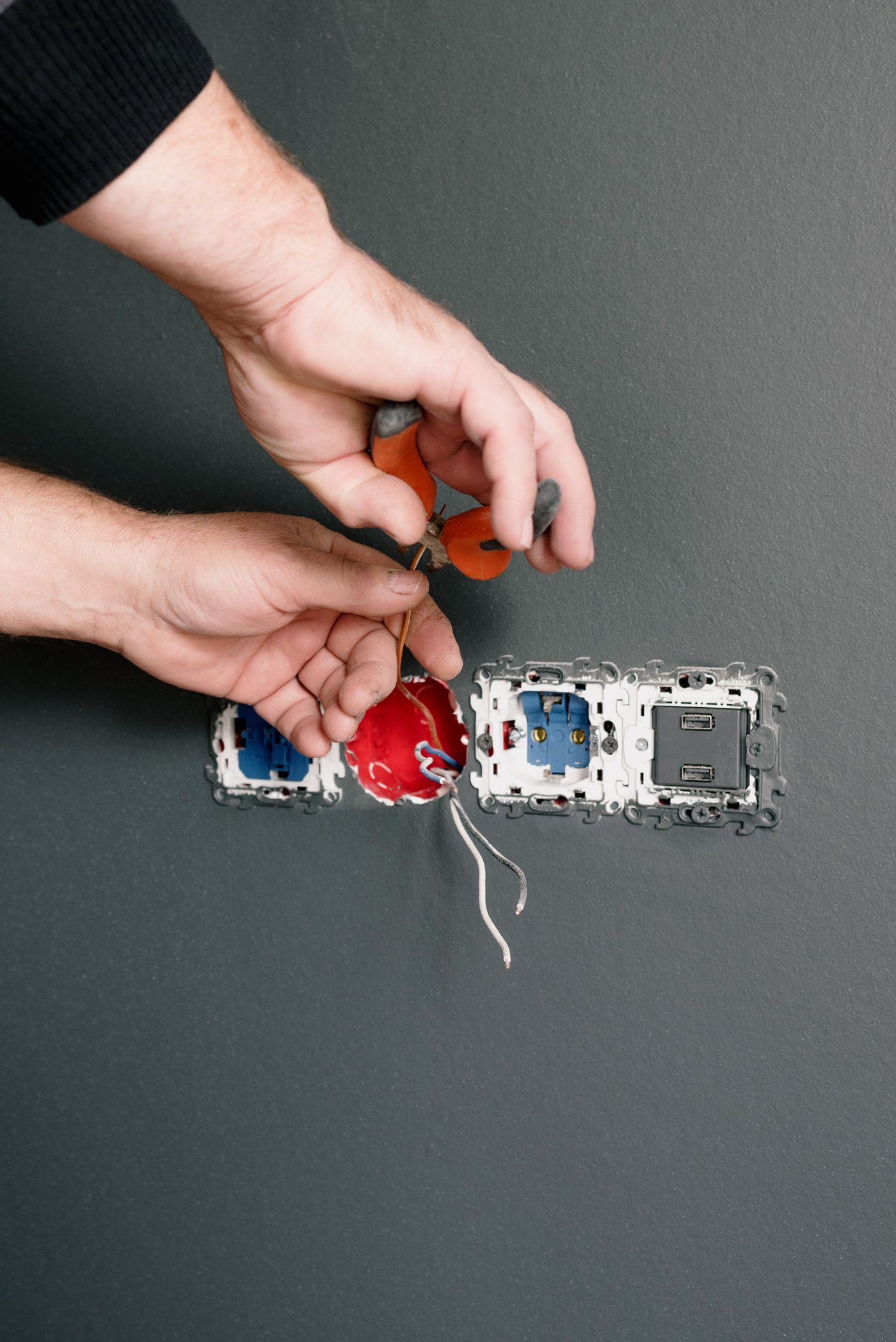 Licensed electrician installing an outlet in a Fort Myers home